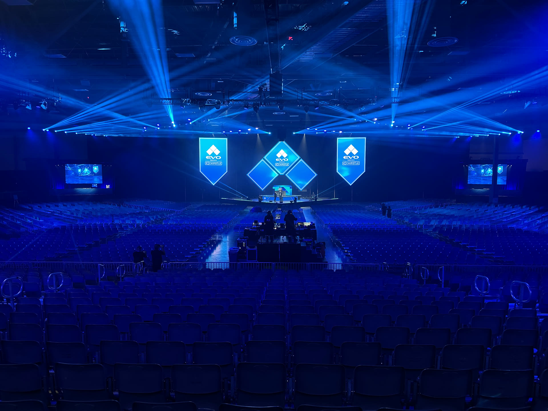 Wide view of the EVO 2026 arena stage, LED displays, lighting beams, and audience seating