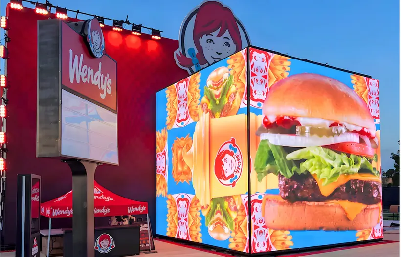 LED cube brand activation with burger content outside a restaurant