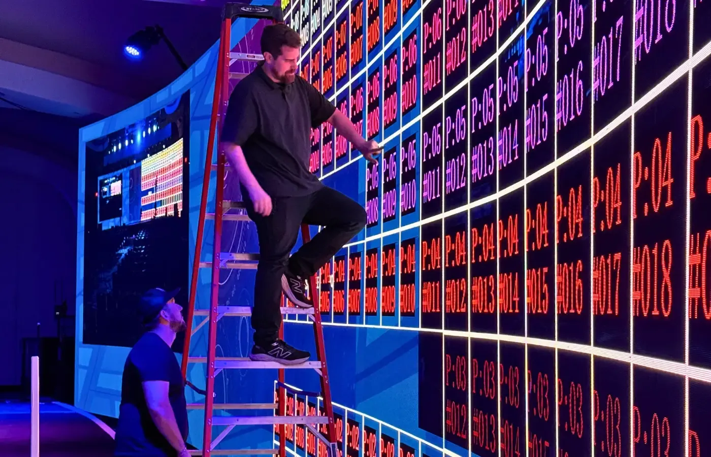 Technicians installing a custom curved LED wall