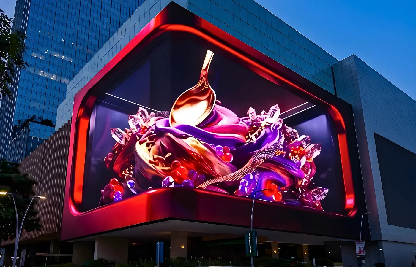 Anamorphic 3D LED corner display on a building facade at dusk