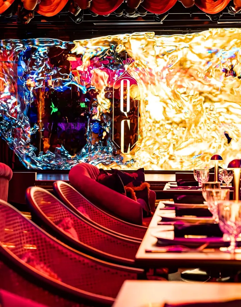 Mirror-finished LED wall above red banquette seating at Solaire North Quezon Club