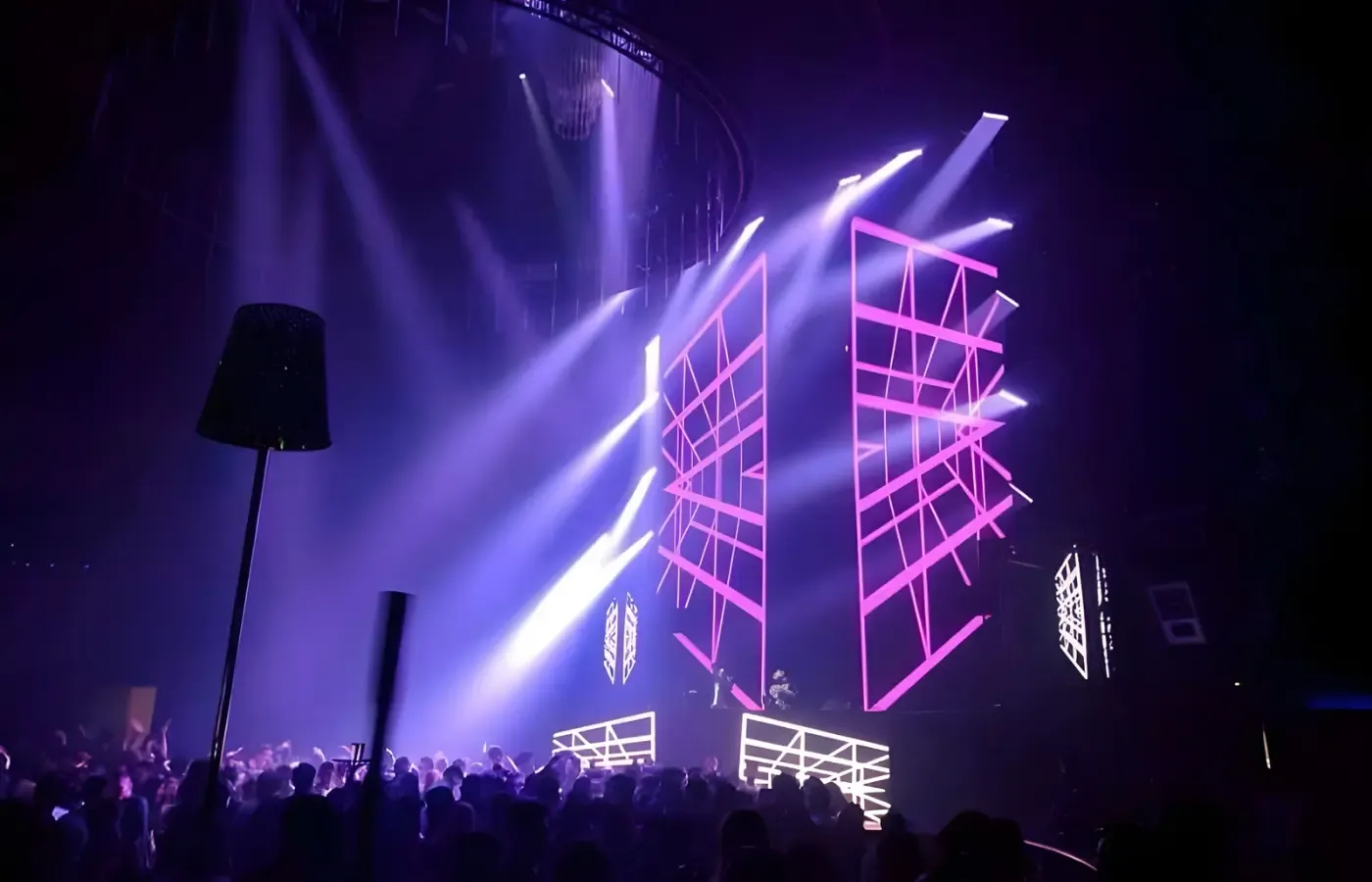 Concert stage with LED structures and moving lights over a crowd