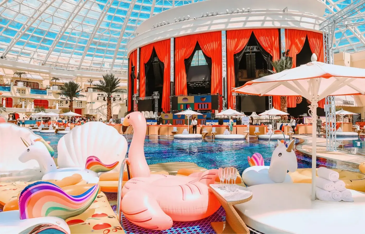 Dayclub pool deck with inflatables under a glass dome