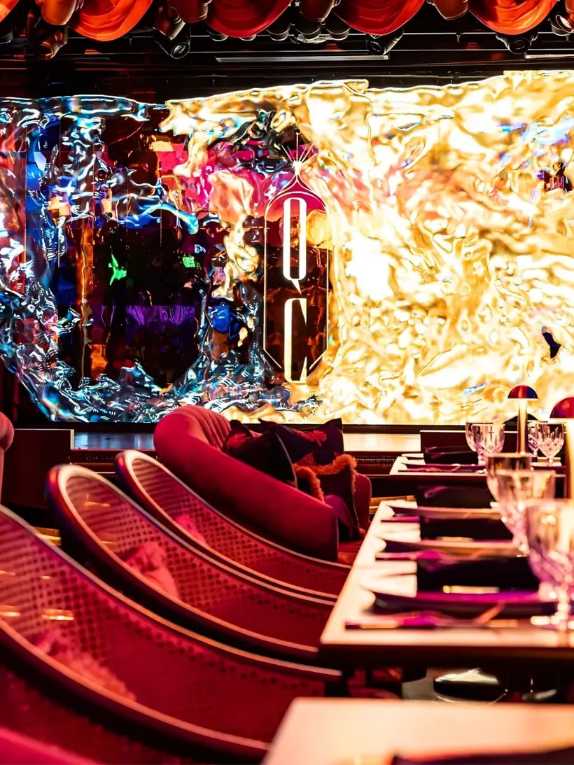 Mirror-finished LED wall above red banquette seating at Solaire North Quezon Club