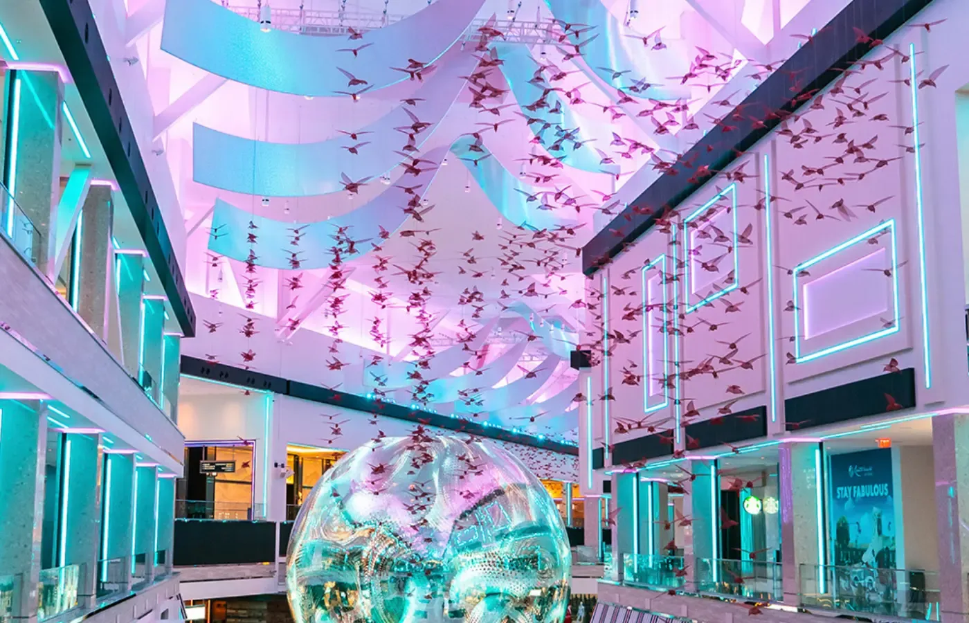 Mall atrium with suspended media installation and illuminated displays