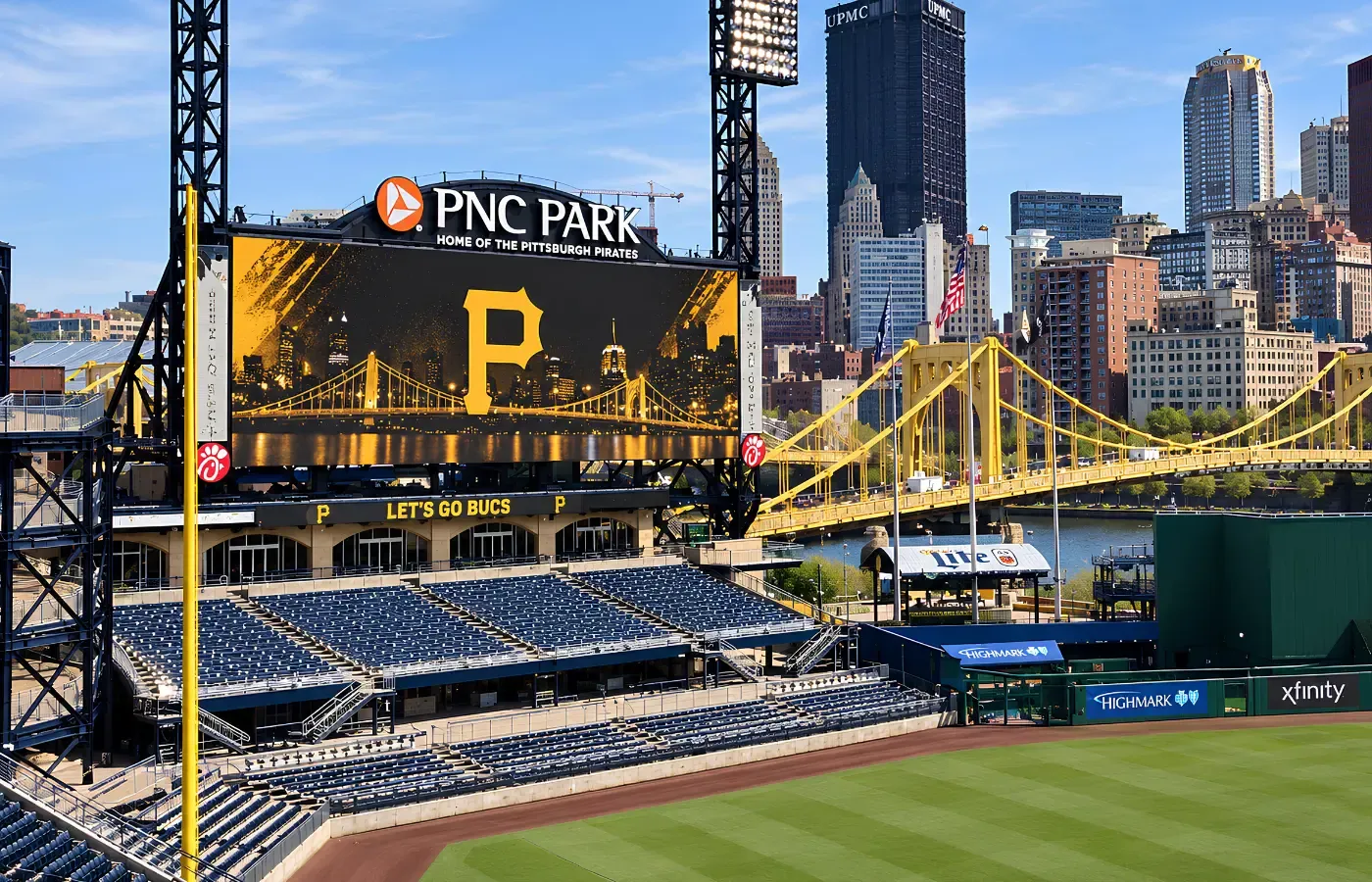 Outdoor ballpark scoreboard and LED displays against the city skyline
